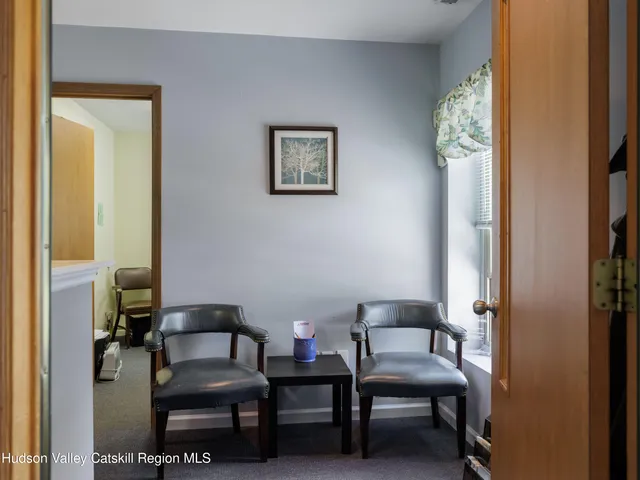 a view of a livingroom with furniture and a chair