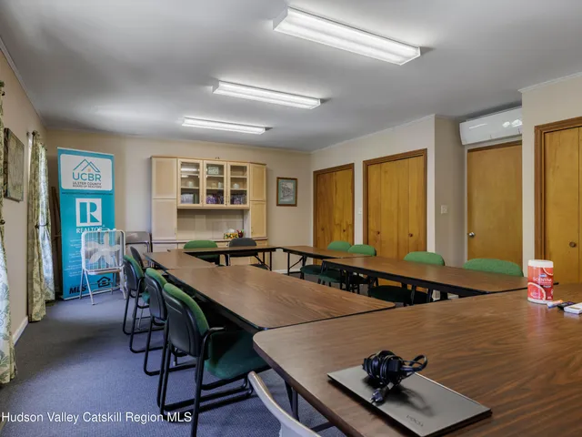 a room with furniture pool table and windows