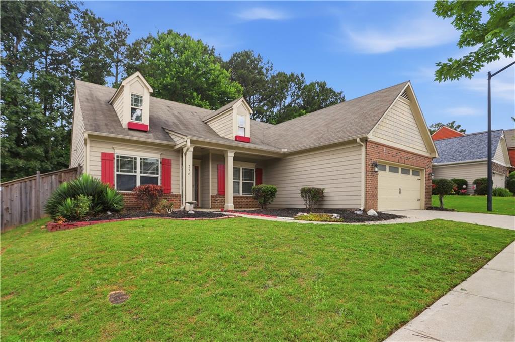 236 Manous Way Canton, GA 30115 - Photo 3 of 25 a front view of a house with a yard and garage