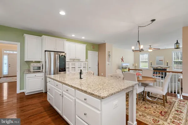 a kitchen with center island table and chairs