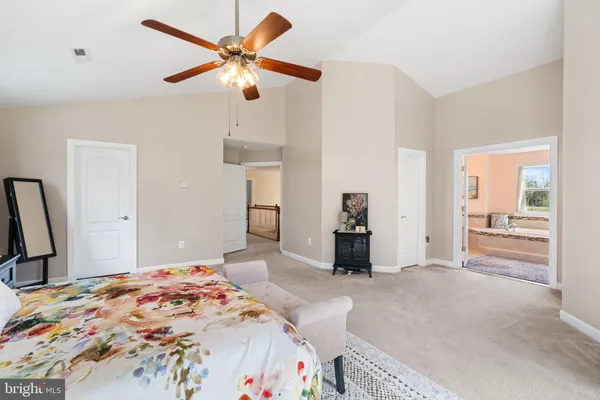 a bedroom with a bed and a large mirror