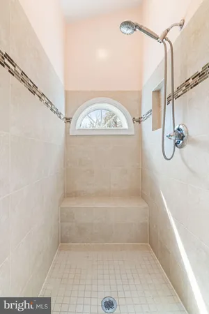 a bathroom with a bath tub with a shower