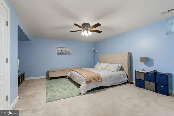 a spacious bedroom with a bed and a chandelier