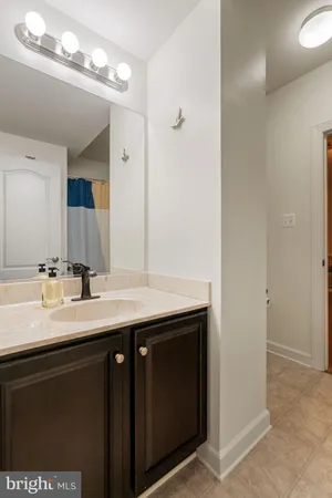 a bathroom with a sink a large mirror and a shower