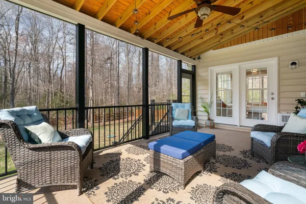 a balcony with furniture and wooden floor