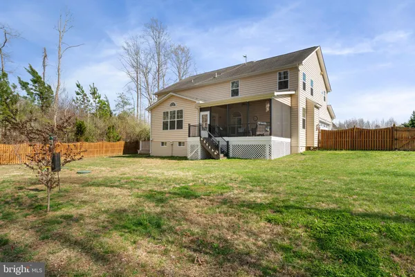 a front view of house with swing and slide