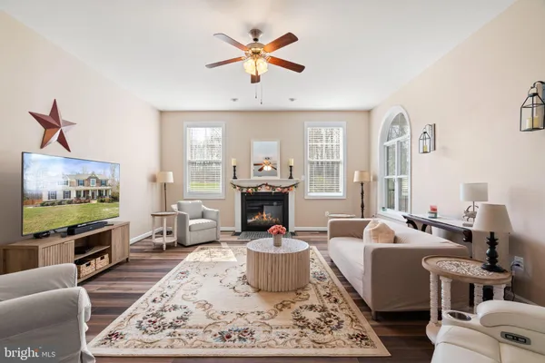 a living room with furniture a fireplace and a flat screen tv