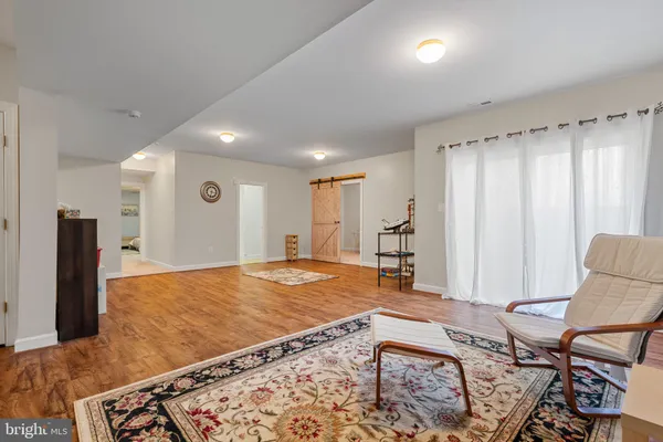 a living room with furniture rug and a table