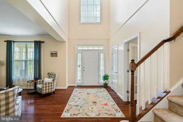 a view of an entryway with wooden floor and windows