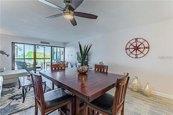 a view of a dining room with furniture window and wooden floor