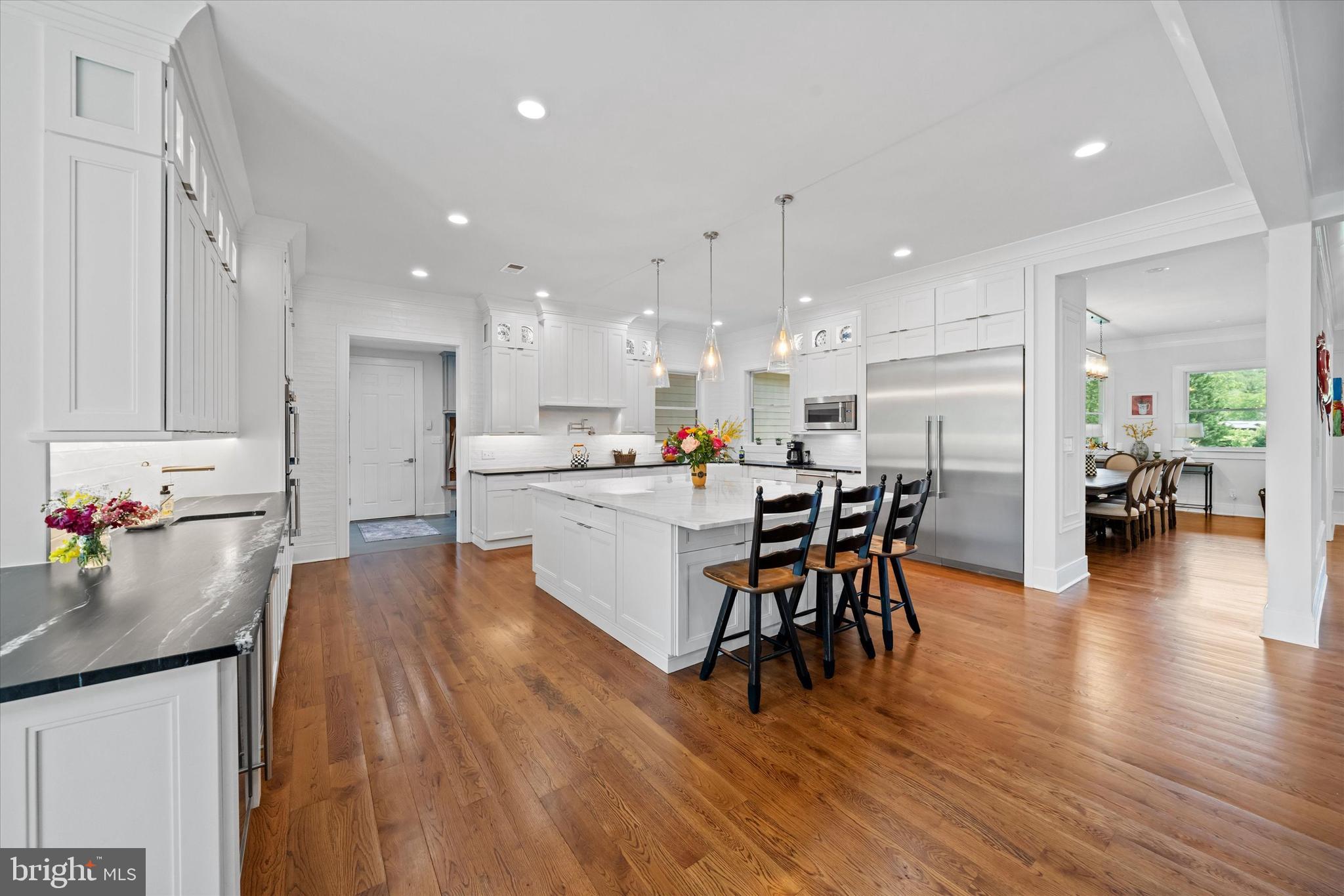 5 Raintree Road Chadds Ford, PA 19317 - Photo 30 of 58 a kitchen with a dining table chairs wooden floor stainless steel appliances and cabinets