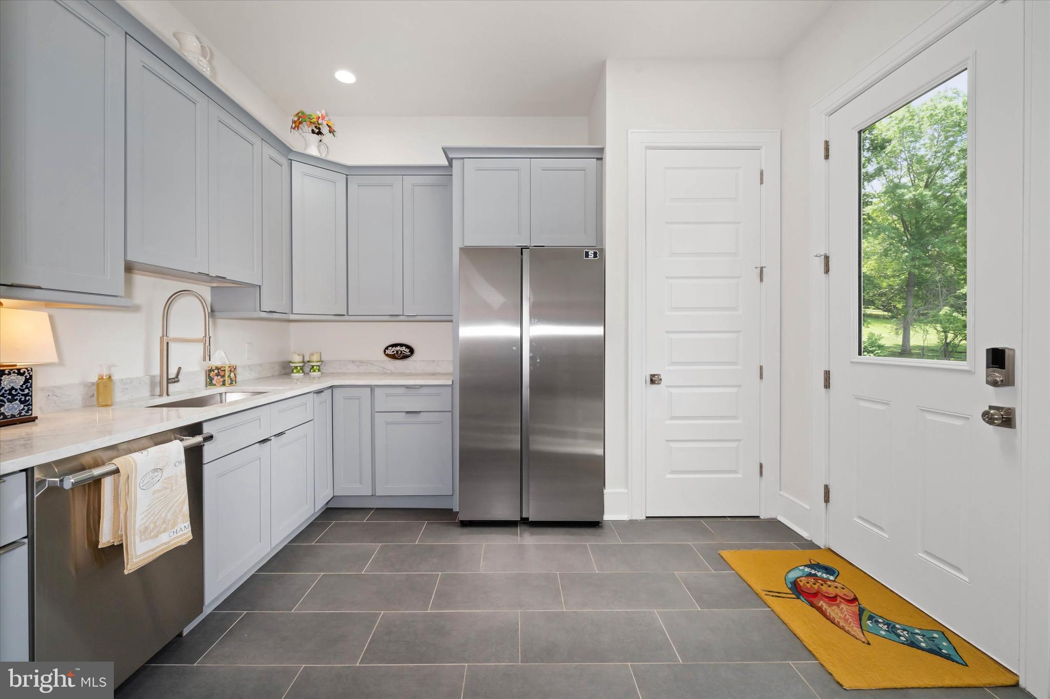 5 Raintree Road Chadds Ford, PA 19317 - Photo 36 of 58 a kitchen with a refrigerator sink and cabinets
