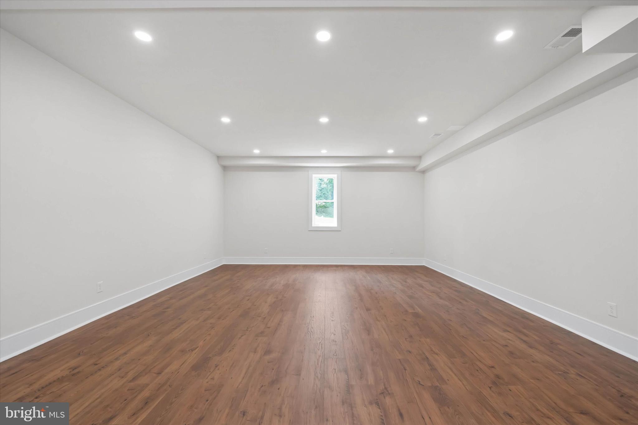 5 Raintree Road Chadds Ford, PA 19317 - Photo 50 of 58 an empty room with wooden floor and windows