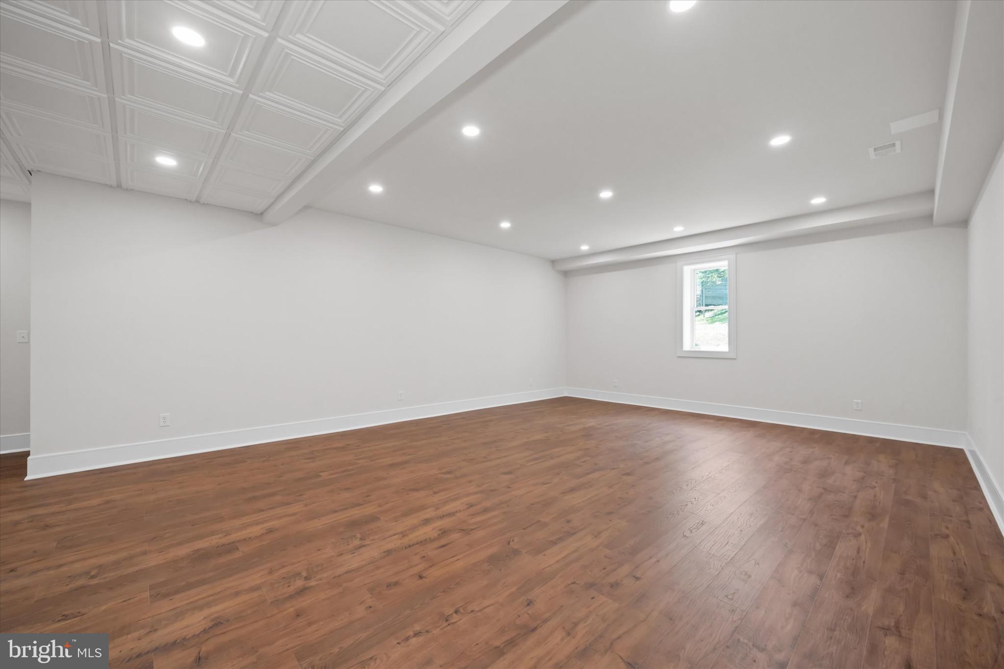 5 Raintree Road Chadds Ford, PA 19317 - Photo 52 of 58 an empty room with wooden floor and windows