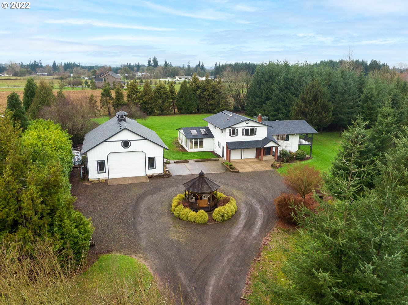 21114 Northwest 43rd Avenue Ridgefield, WA 98642 - Photo 1 of 32 a aerial view of a house with swimming pool and lake view