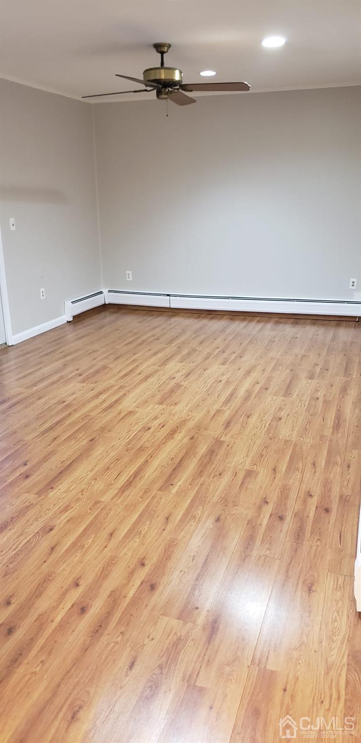 8 Mockingbird Road Edison, NJ 08820 - Photo 3 of 32 a view of an empty room with wooden floor