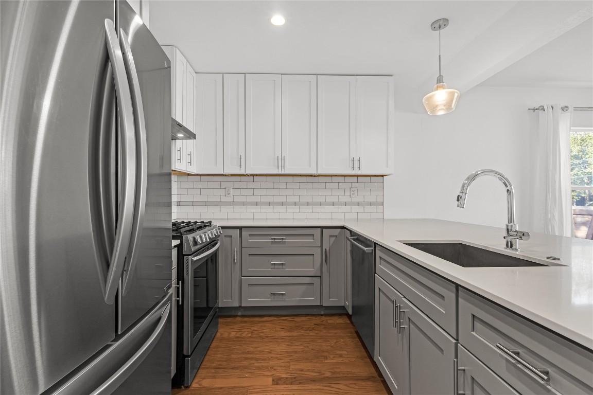 713 East 45th Street Austin, TX 78751 - Photo 11 of 28 a kitchen with granite countertop a sink and refrigerator