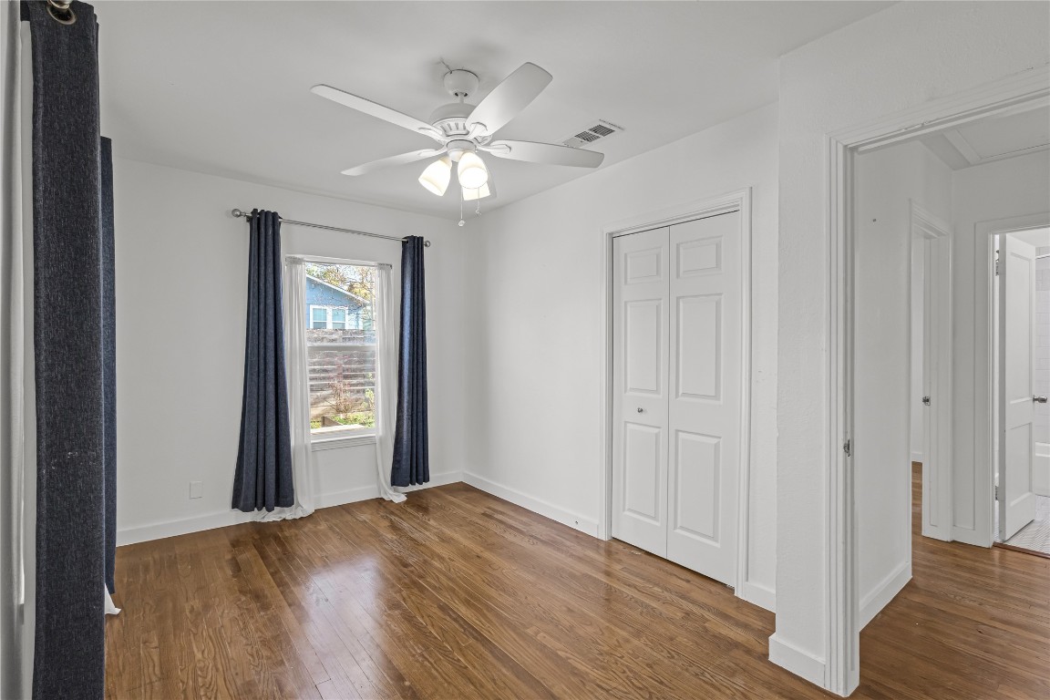 713 East 45th Street Austin, TX 78751 - Photo 14 of 28 an empty room with wooden floor closet and windows