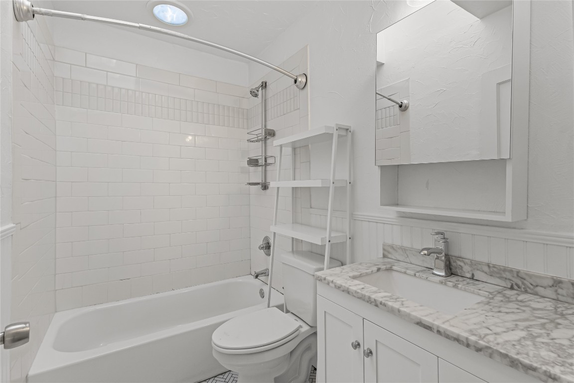 713 East 45th Street Austin, TX 78751 - Photo 16 of 28 a bathroom with a granite countertop sink toilet and shower