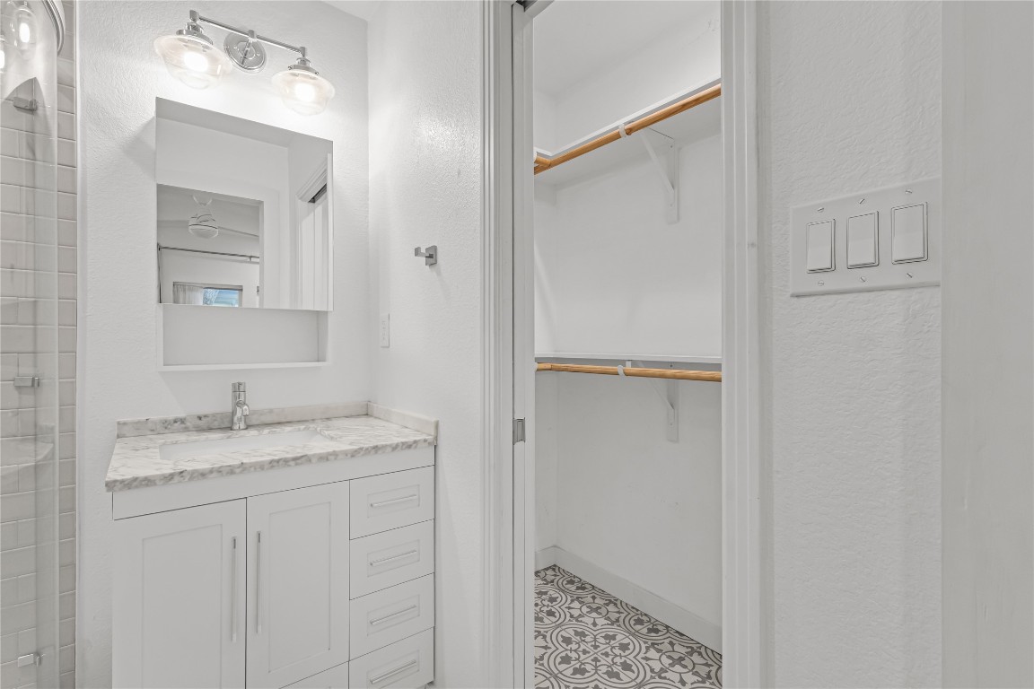 713 East 45th Street Austin, TX 78751 - Photo 23 of 28 a bathroom with a granite countertop sink and mirror