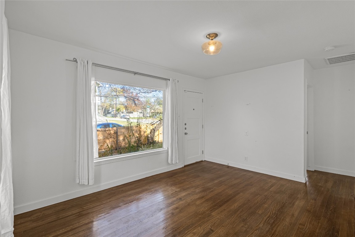 713 East 45th Street Austin, TX 78751 - Photo 7 of 28 wooden floor in an empty room with a window