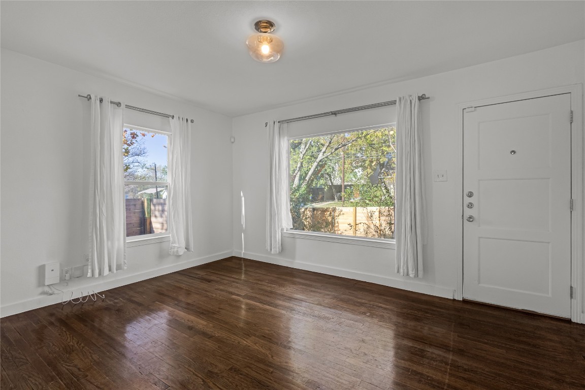 713 East 45th Street Austin, TX 78751 - Photo 8 of 28 an empty room with wooden floor and windows