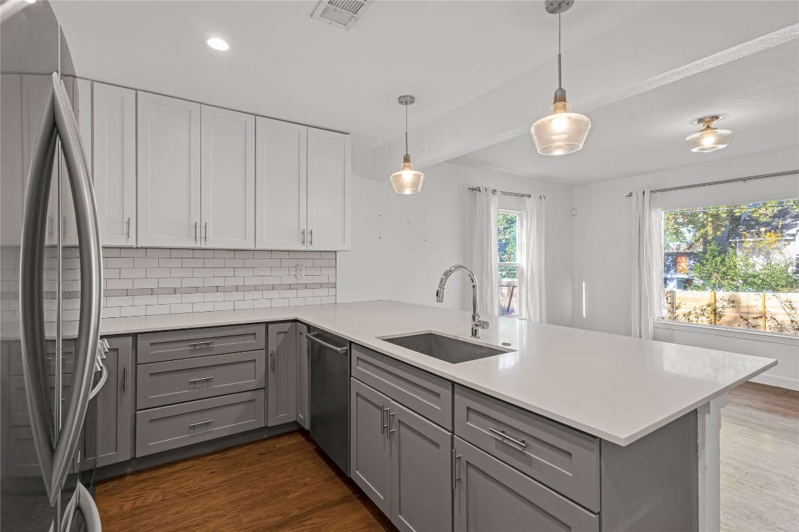 713 East 45th Street Austin, TX 78751 - Photo 10 of 28 a kitchen that has a lot of cabinets in it and wooden floors