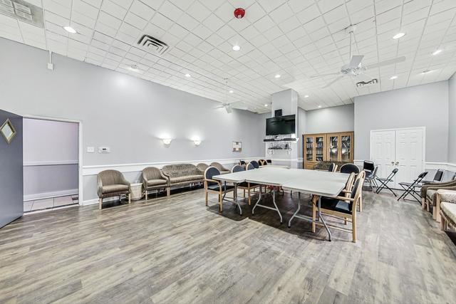 20 North Tower Road, Unit 6J Oak Brook, IL 60523 - Photo 20 of 23 a room with lots of furniture and a wooden floor