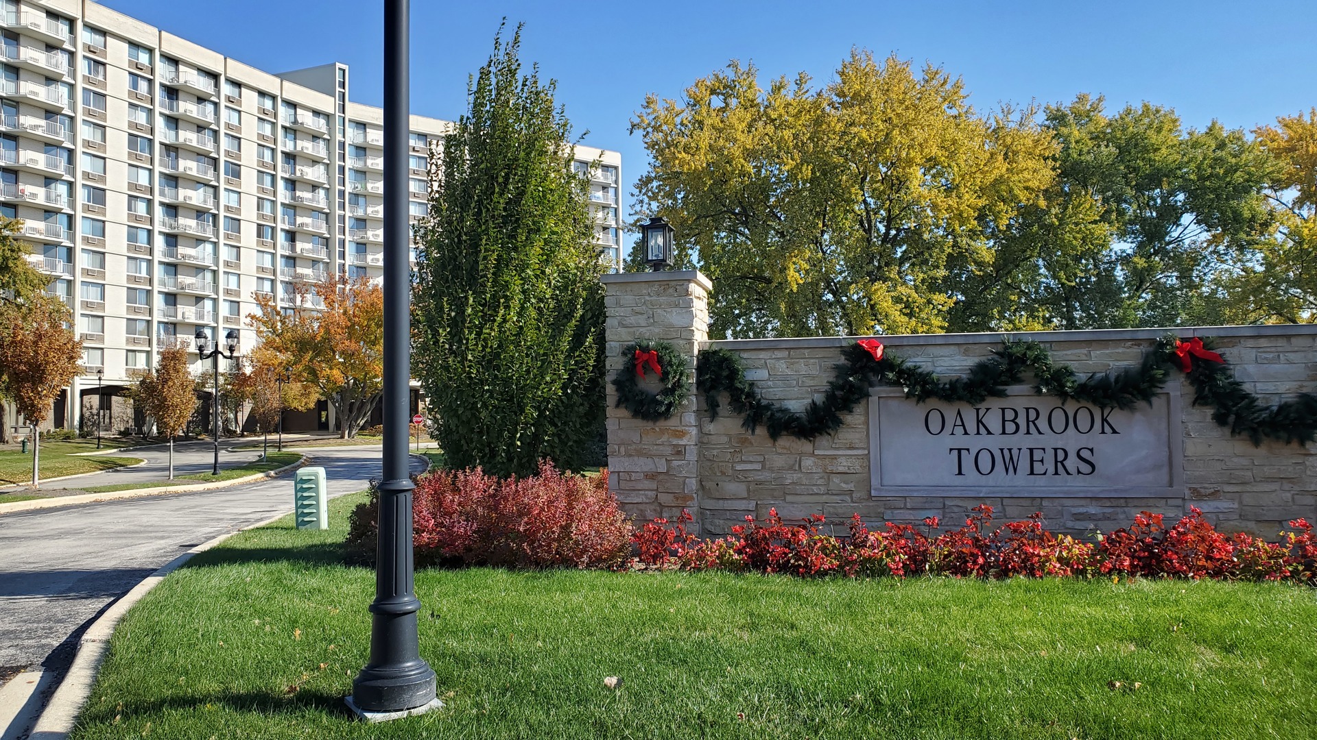 20 North Tower Road, Unit 6J Oak Brook, IL 60523 - Photo 2 of 23 a view of front door of house and yard with green space