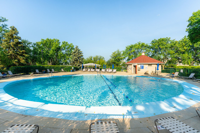 20 North Tower Road, Unit 6J Oak Brook, IL 60523 - Photo 21 of 23 a view of a swimming pool with an outdoor space and seating area
