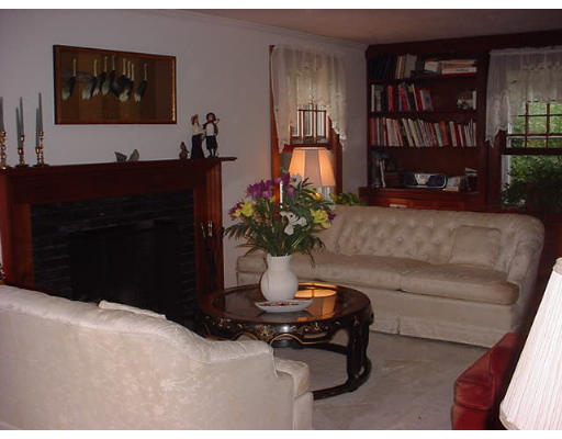185 Viscount Road Longmeadow, MA 01106 - Photo 5 of 8 a living room with furniture potted plant and a bookshelf