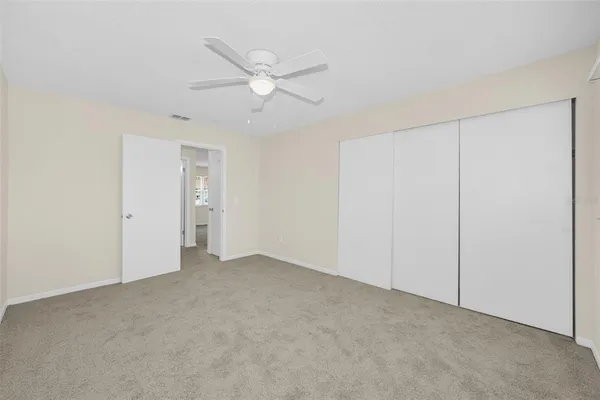 an empty room with a ceiling fan