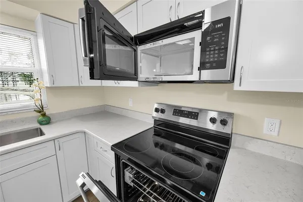 a kitchen with a stove and a microwave