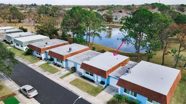 an aerial view of a house with a big yard
