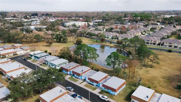 an aerial view of a city with lots of residential buildings and lake view