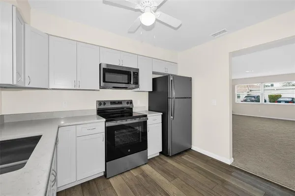 a kitchen with a stove a refrigerator and a sink