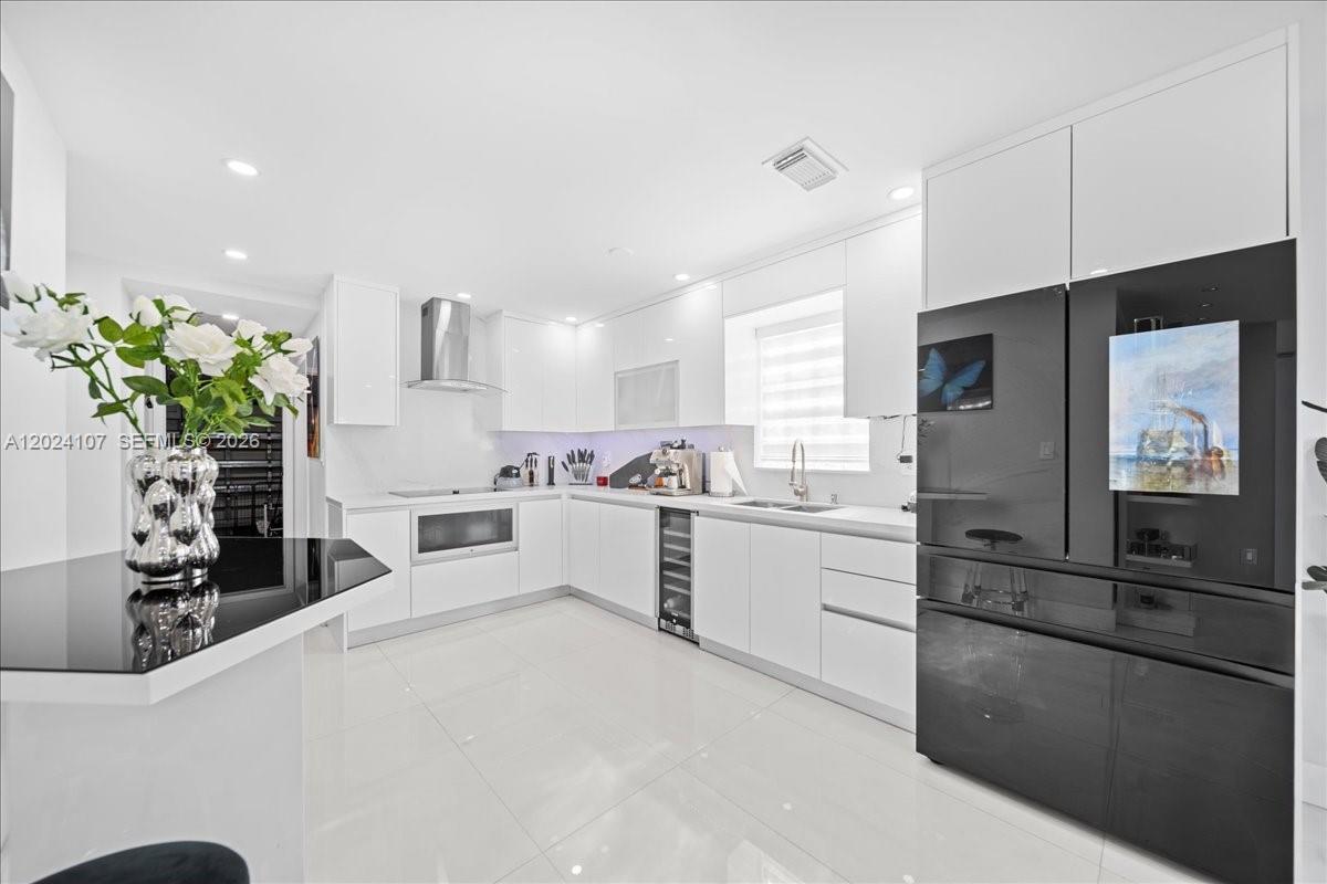 15341 Southwest 36th Street Miami, FL 33185 - Photo 12 of 56 a kitchen with white cabinets and appliances