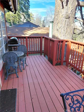 a view of a roof deck with wooden floor and outdoor seating