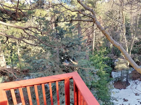 a balcony with tree in the background