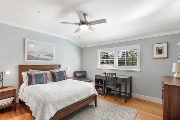 a bedroom with a bed a table and a window