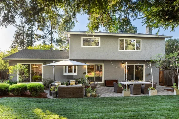 a front view of a house with garden and porch