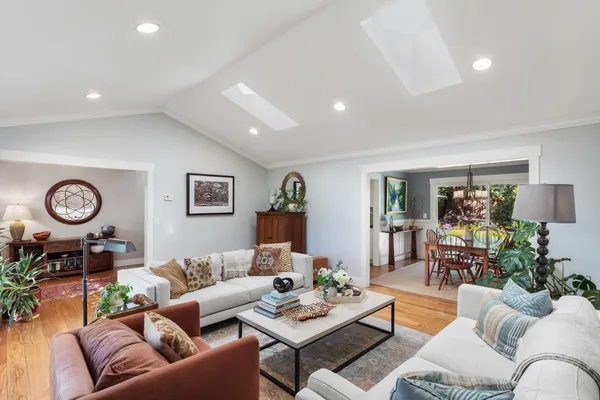 a living room with furniture a clock and a table