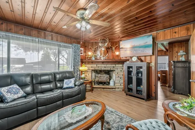 a living room with furniture a fireplace and a table