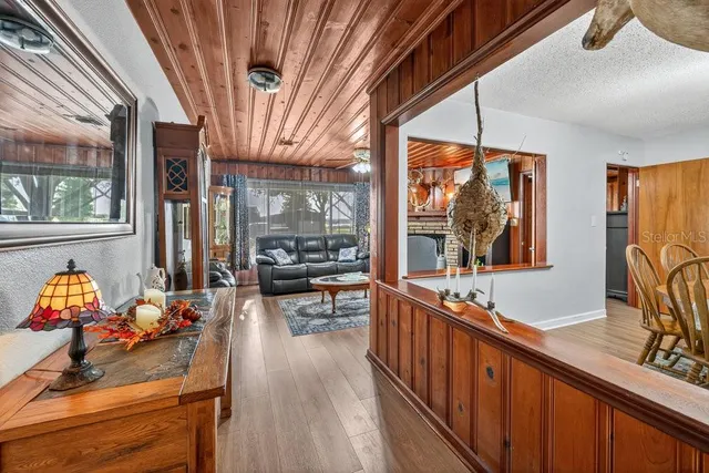 a living room with furniture a flat screen tv and a large window