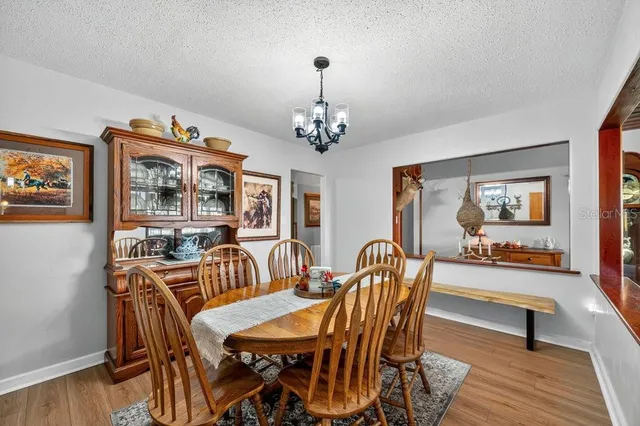 a view of a dining room with furniture wooden floor and a chandelier