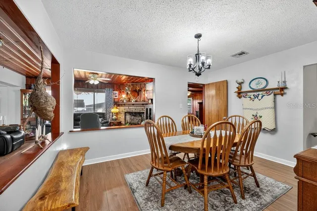 a dining room with furniture a chandelier and window