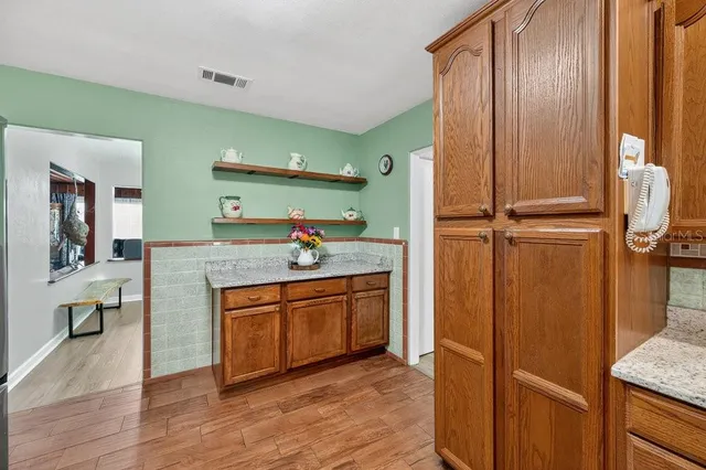 a spacious bathroom with a granite countertop sink and a mirror