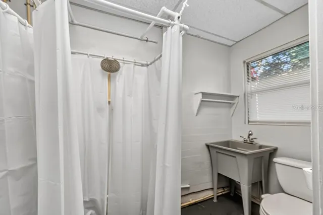 a bathroom with a sink a mirror and a toilet