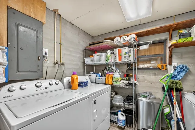 a utility room with dryer washer and shoe rack