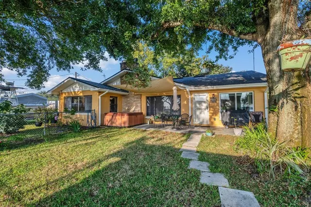 a front view of a house with swimming pool having outdoor seating